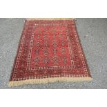 An Afghan rug, with an allover geometric design red field.