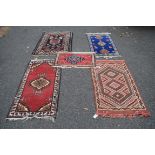 An assortment of five rugs, to include; Persian, Moroccan, Indian and Turkish.