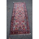 A Persian Lilihan runner, with an all over floral design on a cream field, 210 x 82cm.