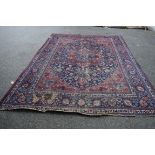 A large Persian Mashad carpet, with central lobed medallion on a blue floral field, 400 x 300cm.