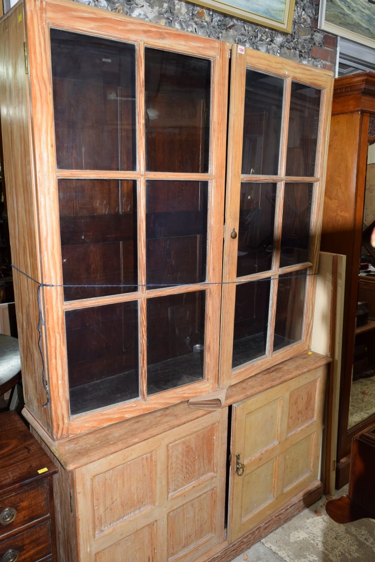 An antique pine bookcase, 135cm wide.