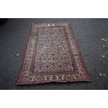 An ivory field Kashan rug, with an allover floral lattice with bird design,