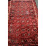 A Turkoman rug, with allover Gul design red field, 250 x 145cm.