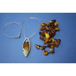 A string of amber pieces; together with a contemporary amber and metal necklet.