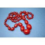 A graduated cherry amber beaded necklace. Condition Report: Length 97cm. Weight 103.