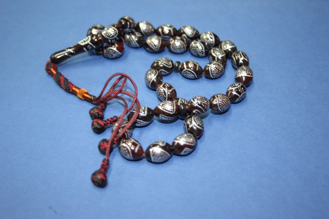 A string of Turkish silver inlaid kuko wood prayer beads.