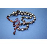 A string of Turkish silver inlaid kuko wood prayer beads.