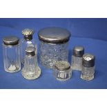 Seven various silver topped bottles and jars.