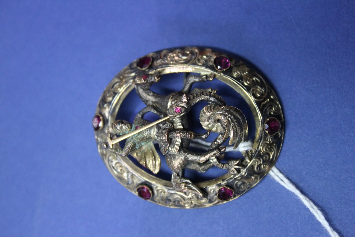 A silver gilt and almandine set brooch,