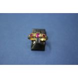 An 18ct gold ring set three rubies and two diamonds.