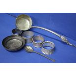 Four various silver napkin rings and a teaspoon,