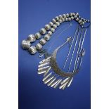 A large white metal bead necklace; together with an Eastern white metal neck collar;