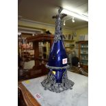 A blue glass decanter having plated mounts and stand.