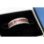 An 9ct gold pave set ruby and diamond half hoop ring.