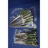 Twenty antique silver bladed and green stained ivory handled knives;