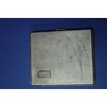 An engine turned silver cigarette case, 85g.