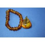 An amber 'sweetie' bracelet; together with an amber pendant.