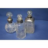 Three silver mounted cut glass bottles.