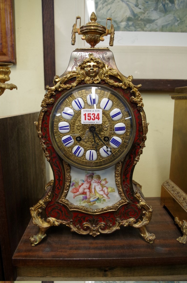 A Louis XVI style tortoiseshell boulle clock and porcelain mantel clock, 40cm high.