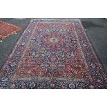 A Persian Kashan carpet, having large central medallion on blue floral field. 345 x 225cm.