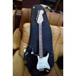 A Fender Squier Strat electric guitar, in padded bag; together with Squier SP10 amp.
