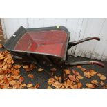 An antique painted wood wheelbarrow, with iron tyre.