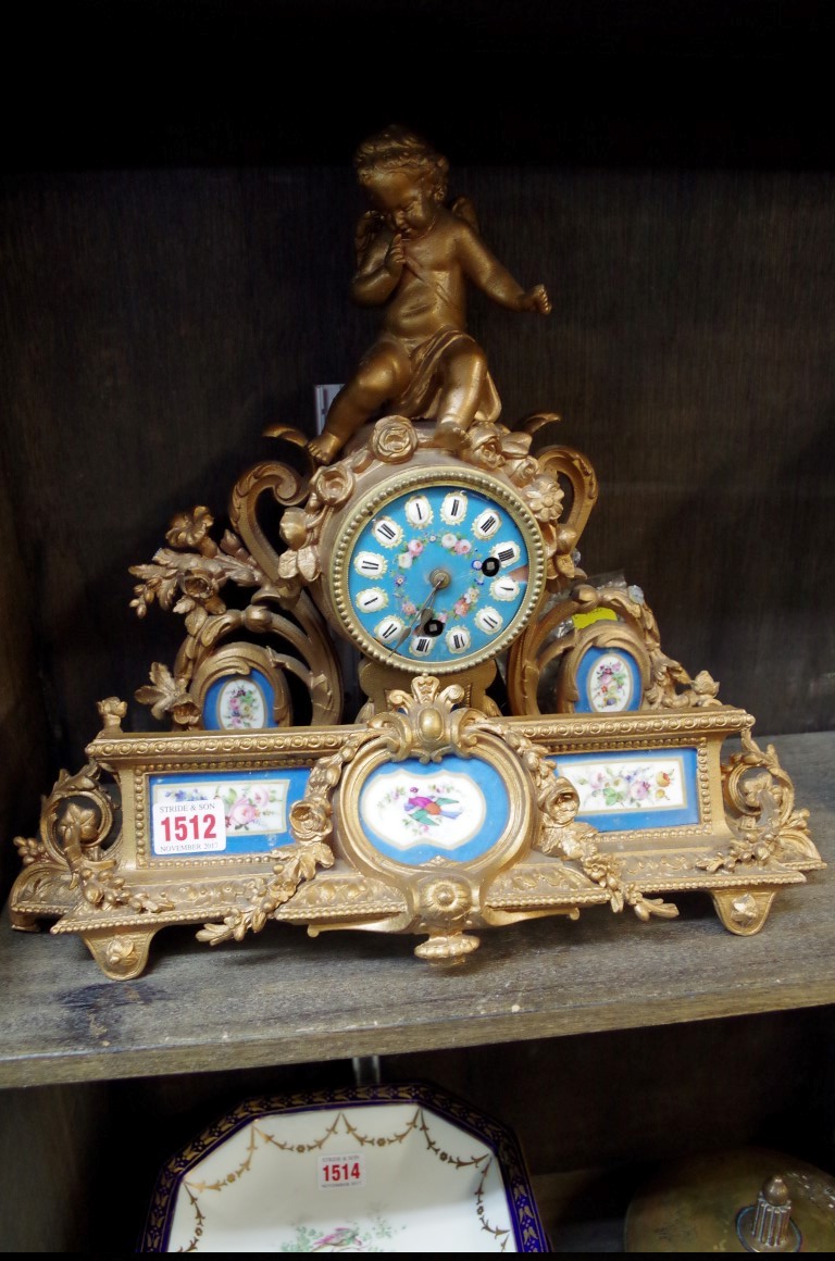 A late 19th century gilt spelter and porcelain mounted mantel clock, 38cm wide.