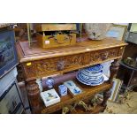 A late Victorian carved oak three tier buffet, labelled 'Pantechnicon Bedford', 107.5cm wide.