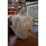 An antique pottery twin handled amphora, 52cm high.