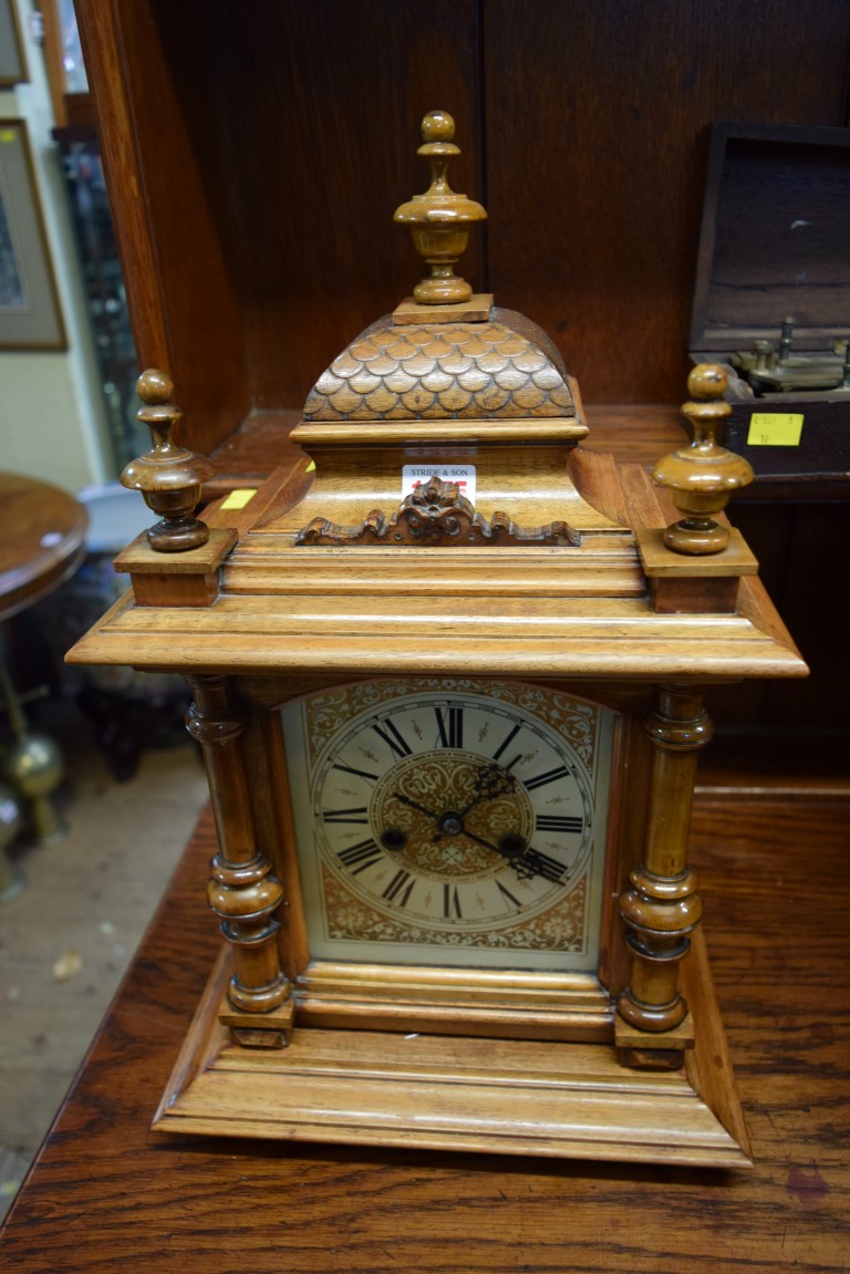 A Continental walnut mantel clock, 47cm high.