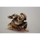 A Japanese carved ivory netsuke of a dancing man, Meiji period, 4cm wide.