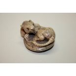 A Japanese carved tagua nut netsuke of a rat, signed Shishinkei, 19th century, 4.5cm wide.