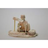 A Japanese carved ivory okimono of a gardener, signed, Meiji period,