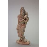 A Japanese carved ivory okimono of a travelling entertainer, Meiji period,