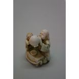 A Japanese carved ivory netsuke, signed Masatomo, with a barrell on his back, 4.2cm high, (s.d.