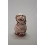 A Japanese carved ivory netsuke of a shishi and ball, signed, 4.