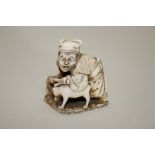 A Japanese carved ivory netsuke of a man with a hoe and a dog, signed and inscribed, 19th century,