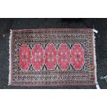 A Pakistan rug, having five pink medallions and stylised floral motifs.