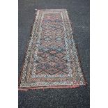 A Kurdish long rug, with allover multicoloured diamond lattice design. 282 x 113cm.