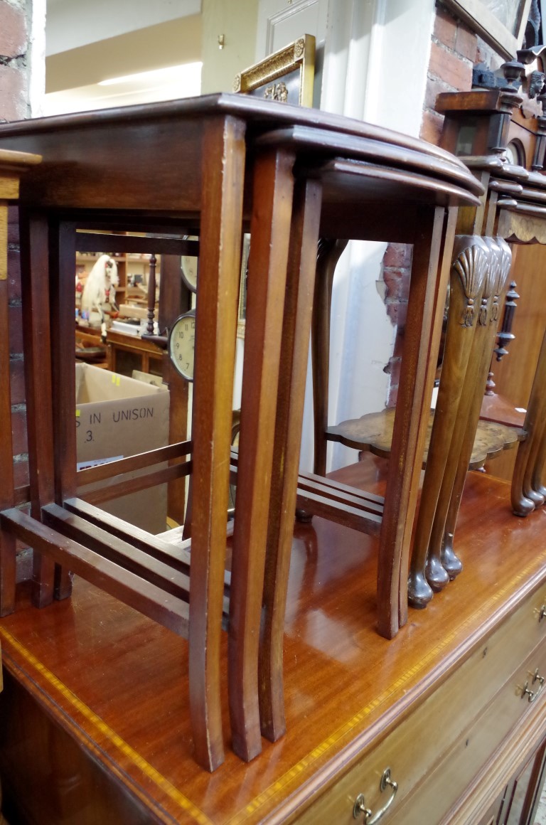 A nest of three mahogany tables, largest 46cm wide.