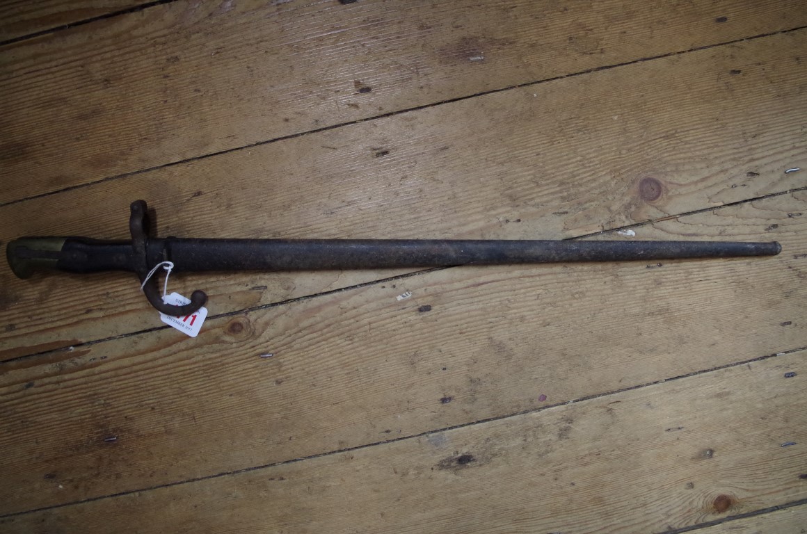 An antique French bayonet and scabbard.
