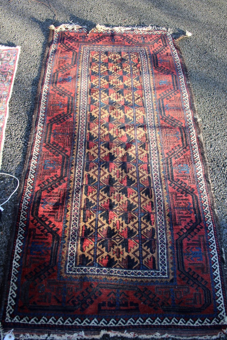 A Beluchi long rug, having allover geometric design on camel ground field.