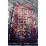A Beluchi long rug, having allover geometric design on camel ground field.