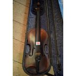 An antique Continental violin, with 14in back, with bow and ebonized case.