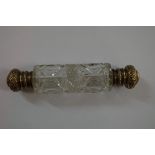 A hobnail cut glass double ended perfume bottle, having hinged gilt metal caps, 12.5cm.