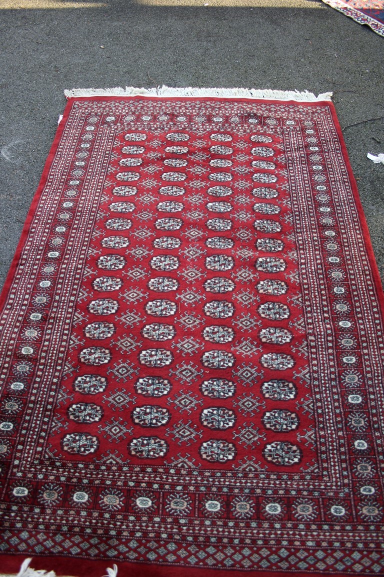 Two Pakistan Bokhara design rugs; together with a Pakistan runner;