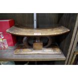 Ethnographica: an African carved wood head rest, 29cm wide; together with a stoneware vase.