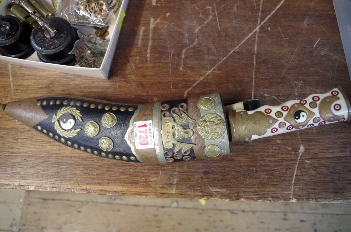 A Nepalese kukri and scabbard, with inlaid bone handle.