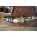 A Nepalese kukri and scabbard, with inlaid bone handle.
