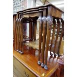 A nest of three figured walnut tables, largest 57.5cm wide.